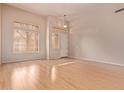 Bright living room featuring beautiful wood floors and neutral paint at 21373 N 94Th Ave, Peoria, AZ 85382