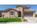 Inviting exterior with desert landscaping, artificial lawn, and a covered entry at 21918 E Maya Rd, Queen Creek, AZ 85142