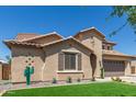Lovely home with a well-maintained front yard and desert-inspired accents at 21918 E Maya Rd, Queen Creek, AZ 85142
