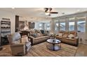Open-concept living room with a ceiling fan, recessed lights, and large windows for natural light at 2221 W Madisen Marie Ave, Queen Creek, AZ 85144