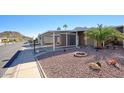 Exterior street view of a home with covered parking and mature landscaping in a desert setting at 2233 E Behrend Dr # 84, Phoenix, AZ 85024