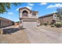 Attractive two-story house with a two-car garage, long driveway, and well-kept low maintenance yard at 2412 W Camp River Rd, San Tan Valley, AZ 85144