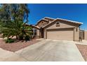 Charming single-Gathering home featuring a desert-style landscape, a two-car garage, and a neutral color palette at 24806 W Hidalgo Dr, Buckeye, AZ 85326