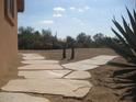 A desert landscape features native plants and decorative gravel with a flagstone walkway at 27239 N 64Th Way, Scottsdale, AZ 85266