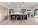 Modern kitchen features a large island with bar stools and stainless steel appliances at 31226 N Granite Reef Rd, Scottsdale, AZ 85266