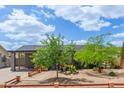 Inviting home exterior showcasing mature trees and a well-maintained yard at 313 W Utopia Rd, Phoenix, AZ 85027