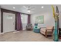 Cozy living room with tiled floors, ceiling fan, and stylish decor at 313 W Utopia Rd, Phoenix, AZ 85027