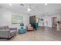 Bright and airy living room with stylish furniture and a ceiling fan at 313 W Utopia Rd, Phoenix, AZ 85027