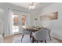 Cozy dining area with a round table, stylish chairs, and natural light from the patio doors at 3511 E Baseline Rd # 1214, Phoenix, AZ 85042