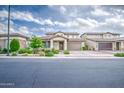 Beautiful front yard with well-maintained landscaping, complemented by a two-car garage and sidewalk at 3879 E Harrison St, Gilbert, AZ 85295