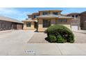 Inviting view of a two-story home with neutral tones and desert landscaping, complemented by a spacious driveway at 43860 W Roth Rd, Maricopa, AZ 85138