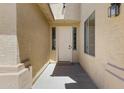 Inviting front entryway with a white door framed by windows and a covered porch for added curb appeal at 43860 W Roth Rd, Maricopa, AZ 85138