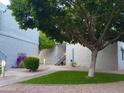 Beautiful courtyard with lush green grass and mature trees at 4444 E Paradise Village N Pkwy # 251, Phoenix, AZ 85032