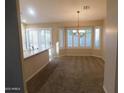 Bright and spacious living room with large windows, plantation shutters and neutral-toned walls at 4613 E Walnut Rd, Gilbert, AZ 85298