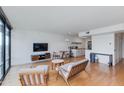 Sun-filled living room featuring hardwood floors, stylish furniture, and a sleek entertainment center at 4808 N 24Th St # 806, Phoenix, AZ 85016