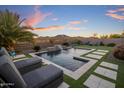 Resort-style backyard pool with water feature, mountain views, basketball hoop, and lounge seating at 537 E Balao Dr, Phoenix, AZ 85085