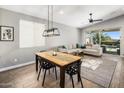 Open dining area with modern chandelier, wood table and views to the backyard with private pool at 537 E Balao Dr, Phoenix, AZ 85085