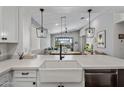 Bright open-concept kitchen with white countertops, a farmhouse sink, and views to the living space at 537 E Balao Dr, Phoenix, AZ 85085