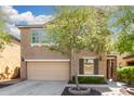 Two-story home featuring an attached two-car garage, meticulous landscaping, and inviting curb appeal at 5423 W Yearling Rd, Phoenix, AZ 85083