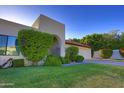 Beautiful desert home with well-maintained landscaping and a tiled roof, featuring an inviting arched entryway at 5718 N 72Nd Pl, Scottsdale, AZ 85250