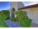 Charming front exterior with lush landscaping, terracotta roof tiles and brick walkway at 5718 N 72Nd Pl, Scottsdale, AZ 85250