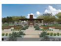 Outdoor dining with fireplace and seating amidst an organic garden with trees and custom plant boxes at 6228 N Cattle Track Rd, Scottsdale, AZ 85250