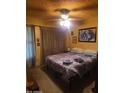 Cozy bedroom featuring a comfortable bed, a ceiling fan, and decorative pictures at 735 E Vaughn Dr, Tempe, AZ 85283