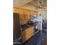 Well-equipped kitchen with stainless steel appliances and bright wooden cabinetry at 735 E Vaughn Dr, Tempe, AZ 85283