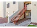Exterior of condo building featuring a red staircase leading to upper-level units at 750 E Northern Ave # 1089, Phoenix, AZ 85020