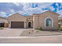 Charming single-Gathering home featuring a stone facade, arched window, and a paved driveway at 8021 E Jasmine St, Mesa, AZ 85207