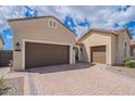 A multi-car garage with a brick paved driveway provides ample parking at this lovely home at 8021 E Jasmine St, Mesa, AZ 85207