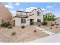 Charming two-story home featuring stone accents, low-maintenance landscaping, and a inviting blue front door at 8043 W Albeniz Pl, Phoenix, AZ 85043