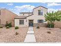 Charming two-story home featuring stone accents, low-maintenance landscaping, and a inviting blue front door at 8043 W Albeniz Pl, Phoenix, AZ 85043