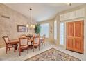 Elegant dining room featuring wood floors, a chandelier, and natural light with views of the front yard at 8242 S Kachina Dr, Tempe, AZ 85284