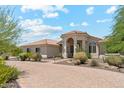 Beautiful home with a tiled roof, arched entry, desert landscaping, and a brick paver driveway at 8540 E Mcdowell Rd # 10, Mesa, AZ 85207