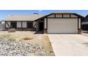 Charming single-story home with a neutral color scheme and a spacious two-car garage at 8571 N 83Rd Dr, Peoria, AZ 85345