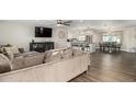 Open-concept living space with hardwood floors connecting the kitchen and dining areas at 8714 E Mackenzie Dr, Scottsdale, AZ 85251