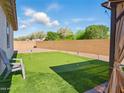 Serene backyard featuring a putting green and comfortable outdoor seating area at 9310 W Atlantis Way, Tolleson, AZ 85353