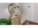Elegant foyer with decorative mirror, console table, and neutral color scheme at 11360 E Keats Ave # 70, Mesa, AZ 85209