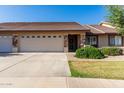 Inviting home exterior with a well-maintained lawn, a spacious driveway, and a charming facade at 11360 E Keats Ave # 70, Mesa, AZ 85209