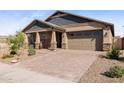 Welcoming home featuring a brick-paved driveway, desert landscaping, and a two-car garage at 12269 E Chiricahua Pl, Gold Canyon, AZ 85118