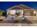 Charming single-story home featuring a manicured desert landscape and well-lit exterior at 12269 E Chiricahua Pl, Gold Canyon, AZ 85118