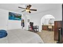 Comfortable bedroom with a ceiling fan, TV, workstation and ensuite bathroom at 12447 N 50Th Ln, Glendale, AZ 85304