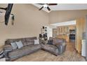 Comfortable living room shows high ceilings, hardwood floors, and flows into the kitchen at 12447 N 50Th Ln, Glendale, AZ 85304