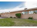 Home exterior featuring a manicured lawn and neatly trimmed shrubbery at 1310 S Pima -- # 6, Mesa, AZ 85210