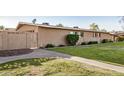 Exterior view of well-maintained home with green lawn and privacy fence at 1310 S Pima -- # 6, Mesa, AZ 85210