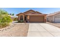 Charming single-story home with a well-maintained front yard, desert landscaping, and a two-car garage at 13145 W Cambridge Ave, Goodyear, AZ 85395