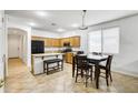 Open-concept kitchen with stainless steel appliances, a central island, and adjacent dining area at 15339 W Jefferson St, Goodyear, AZ 85338
