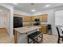 Spacious kitchen with stainless appliances, wood cabinetry, and an island with seating at 15339 W Jefferson St, Goodyear, AZ 85338