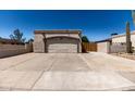 Exterior view featuring a two-car garage, desert landscaping and wide driveway with a private front yard at 19202 N 14Th St, Phoenix, AZ 85024